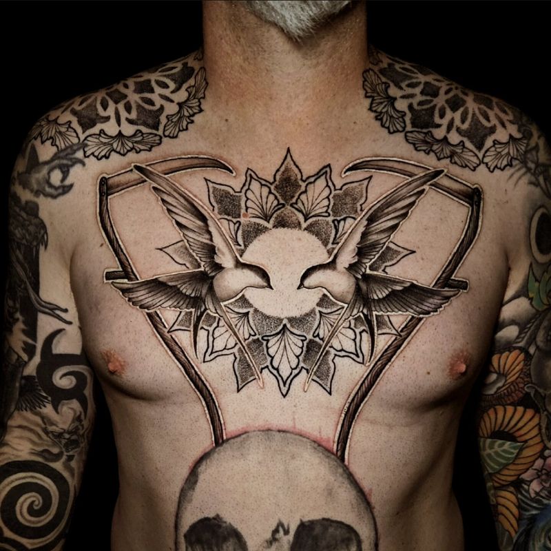 Large blackwork chest piece with two doves over an ornamental mandala