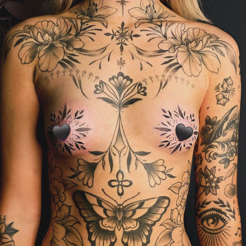 Full torso blackwork: symmetrical florals, botanicals and a large moth across the chest and stomach